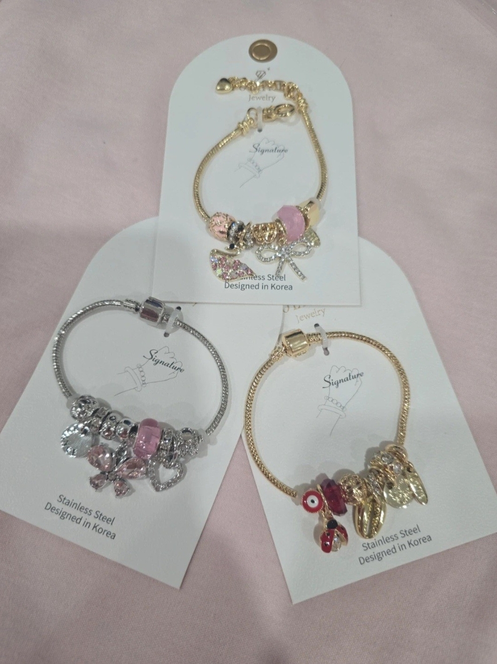 3 Signature Women's Gold and Silver Charm Bracelet Set with Pink Accents